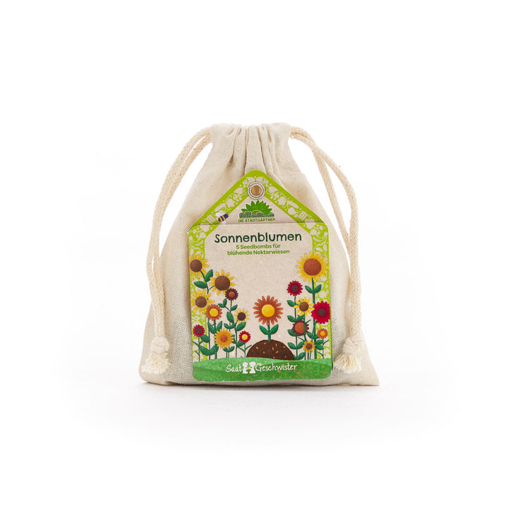 Bolsa de tela con etiqueta “Bombas de Semillas de Girasol” y coloridas ilustraciones de flores.