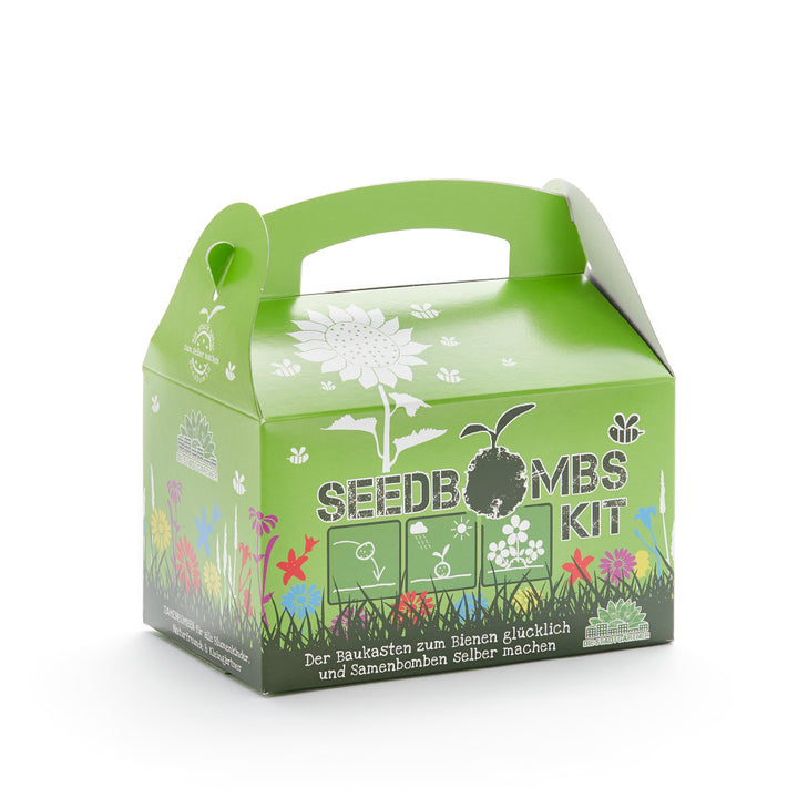 Embalaje verde de un kit de bombas de semillas con un estampado de flores y el lema "El kit para hacer felices a las abejas y bombardear las semillas tú mismo".