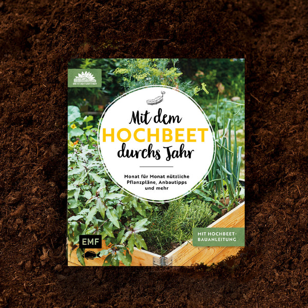Libro de jardinería "Con el bancal elevado durante todo el año" sobre el suelo.
